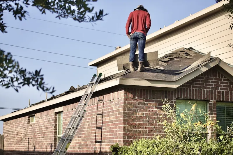 Professional roofer working on a residential roof in Hot Wells